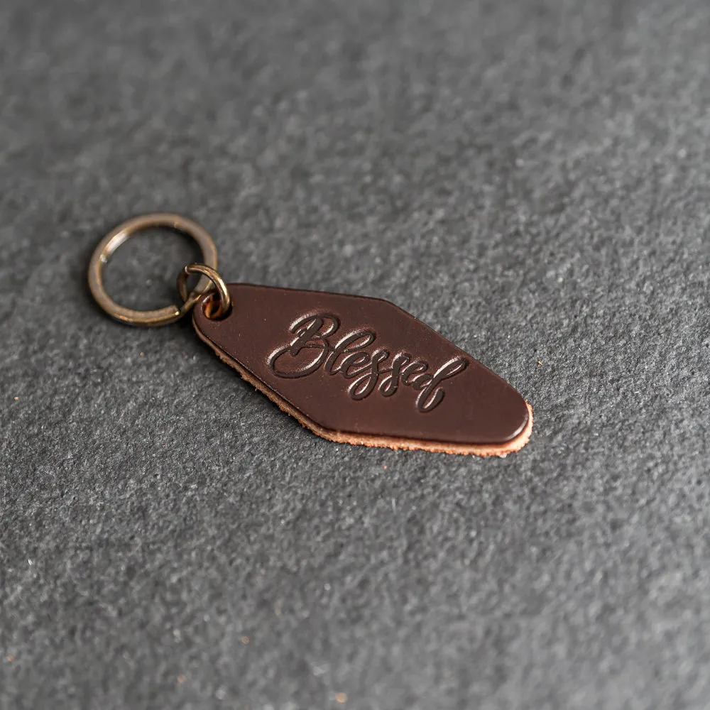 Leather Motel Key Shape Keychain with a Blessed Stamp Design