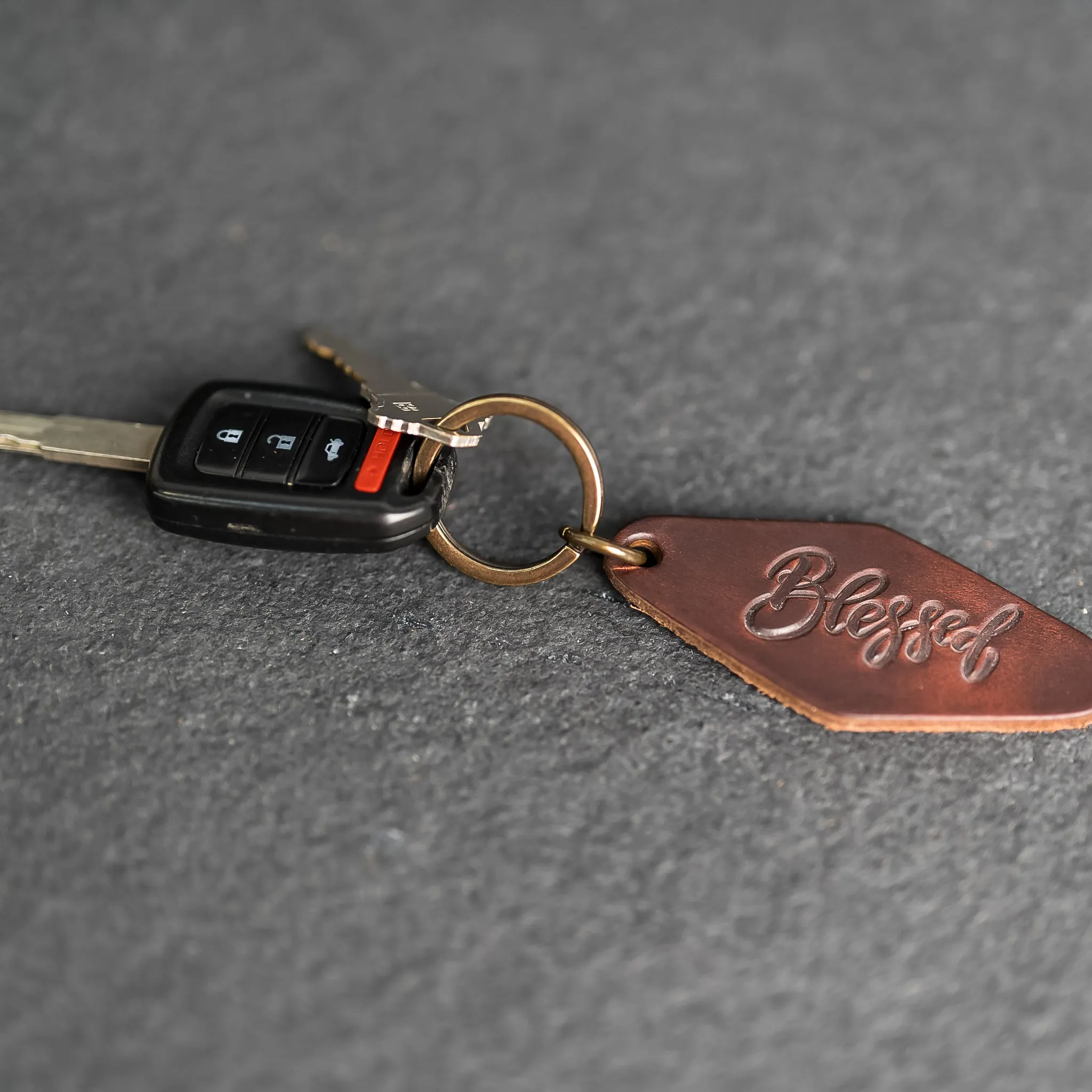 Leather Motel Key Shape Keychain with a Blessed Stamp Design